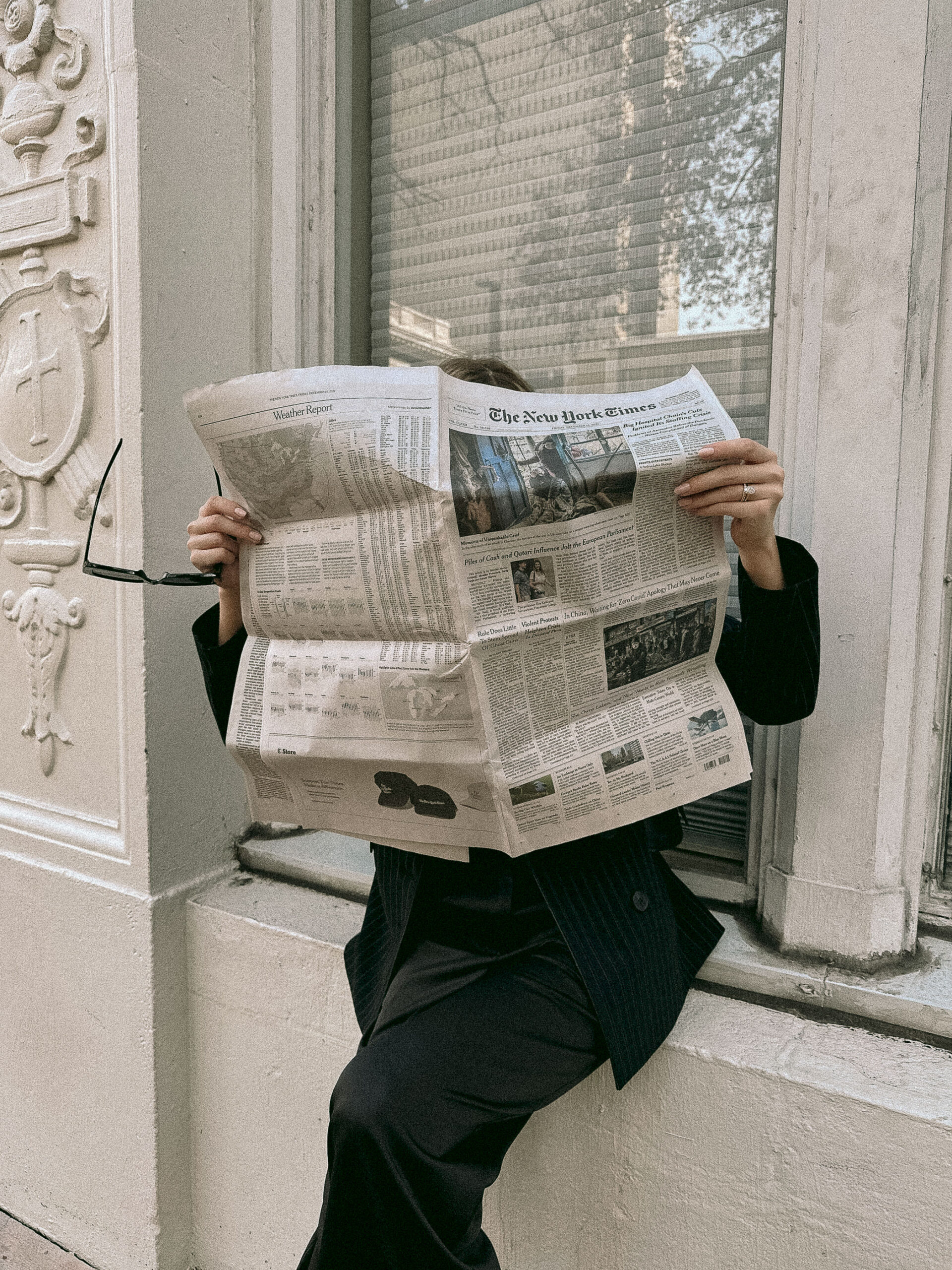 Woman reading a newspaper.