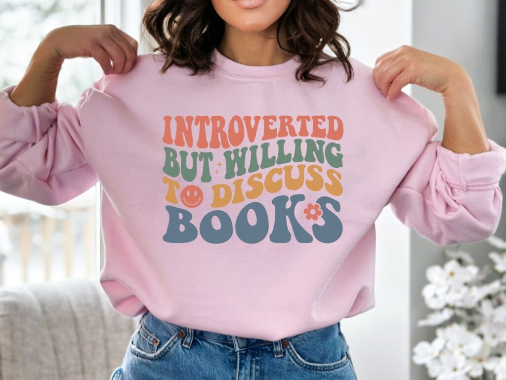 Sweatshirt decorated with text "Introverted But Willing To Discuss Books."