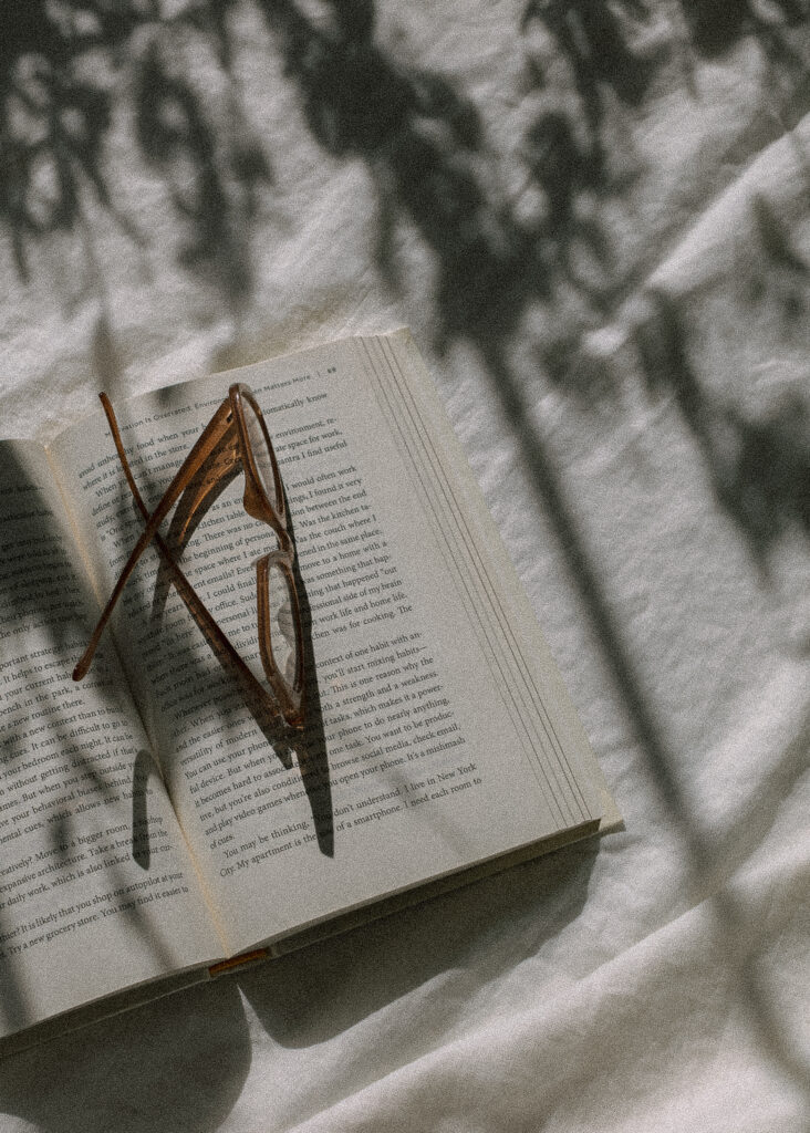 Photo of glasses resting on an open book.