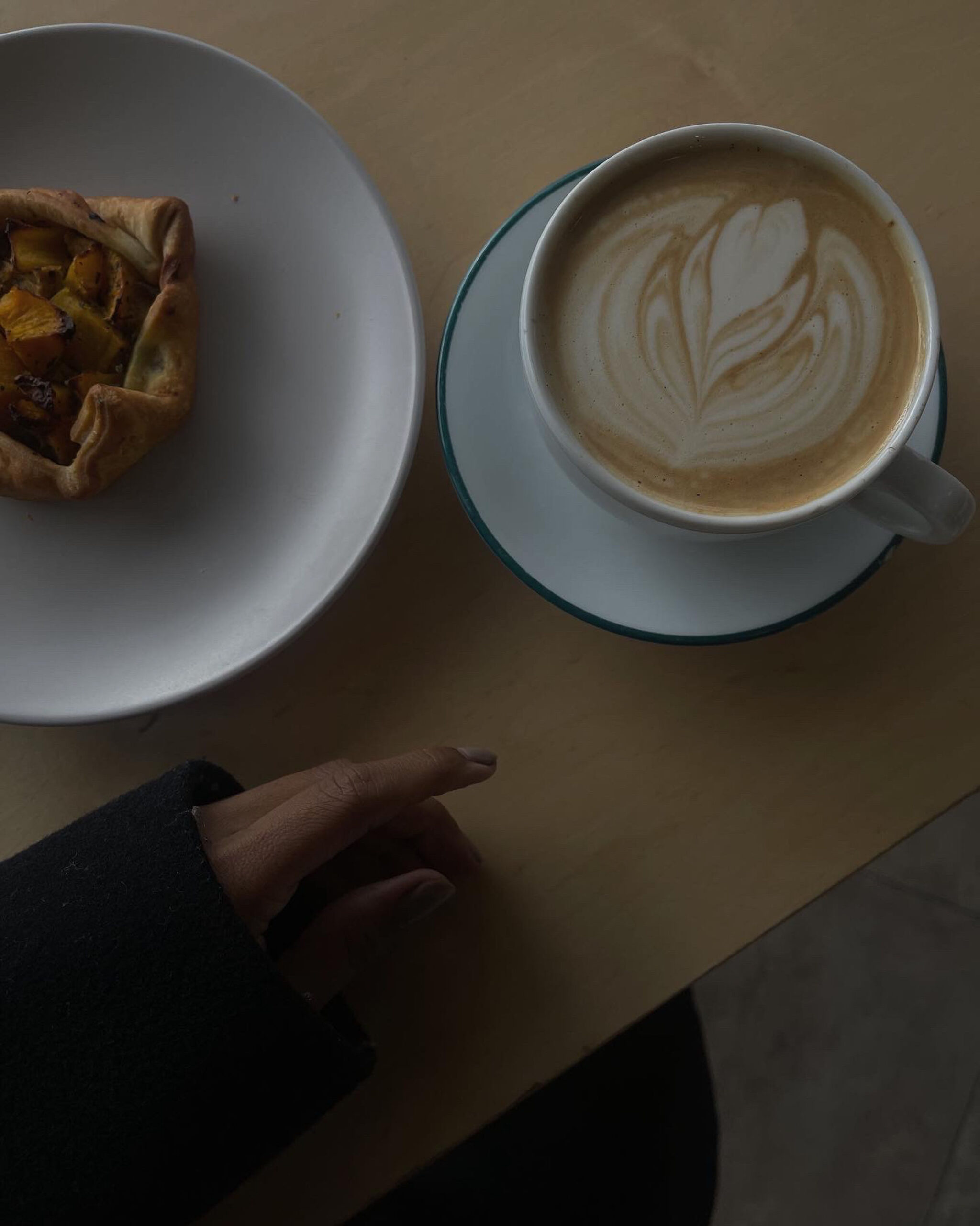 Photo of a pastry and a hot latte.